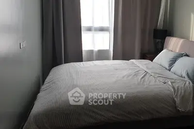 Cozy bedroom with natural light and modern decor in a stylish apartment.