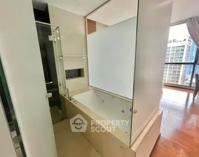 Luxurious bathroom with modern bathtub and city view in high-rise apartment