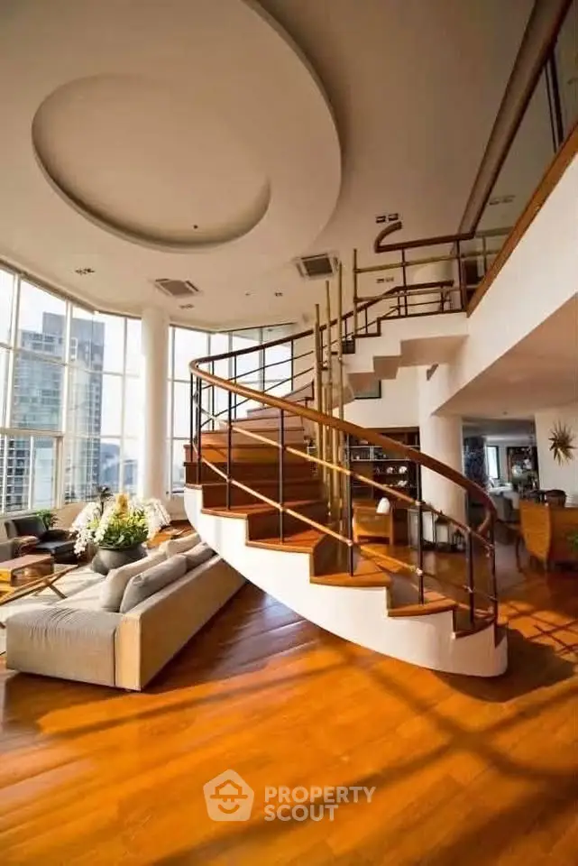 Luxurious living room with stunning spiral staircase and panoramic city views