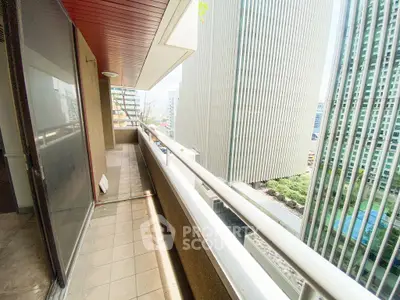 Spacious urban balcony with city skyscraper views, perfect for enjoying the vibrant cityscape.