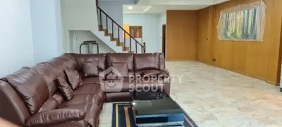 Spacious living room with luxurious leather sectional and modern decor
