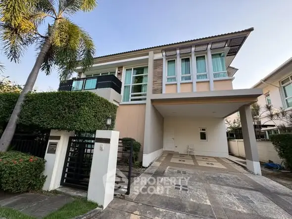 Modern two-story house with large windows and spacious driveway in a serene neighborhood.