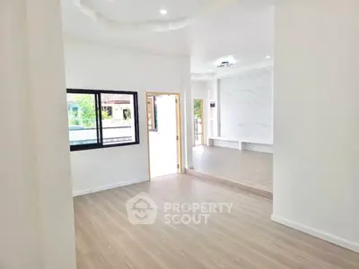 Spacious modern living room with large windows and elegant flooring