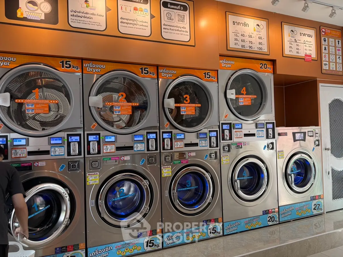 Modern laundry facility with multiple washing machines and dryers, offering convenient self-service options.