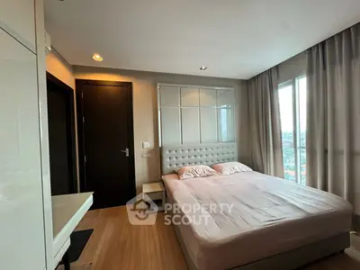 Modern bedroom with large window and stylish decor