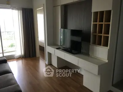 Modern living room with sleek TV unit and natural light