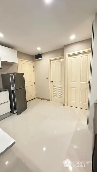 Modern kitchen with sleek design and stainless steel fridge in a bright apartment