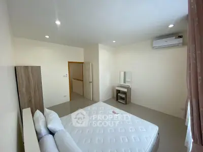 Spacious bedroom with modern furnishings and air conditioning in a bright apartment.