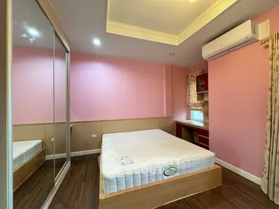 Cozy bedroom with mirrored closet and air conditioning in modern apartment