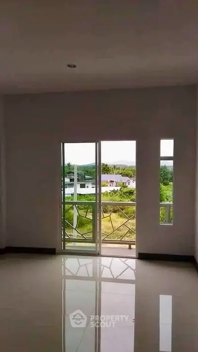 Spacious room with large windows offering a scenic view, perfect for natural light lovers.