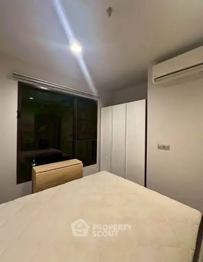 Cozy bedroom with modern air conditioning and ample closet space.