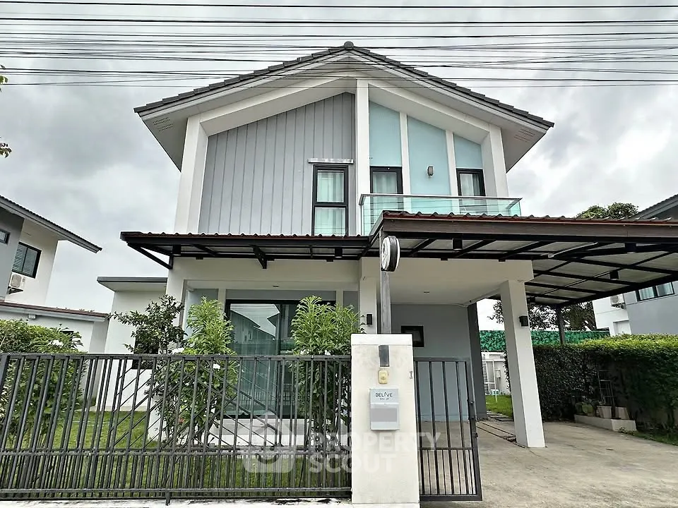 Modern two-story house with sleek design and spacious driveway in a suburban neighborhood.
