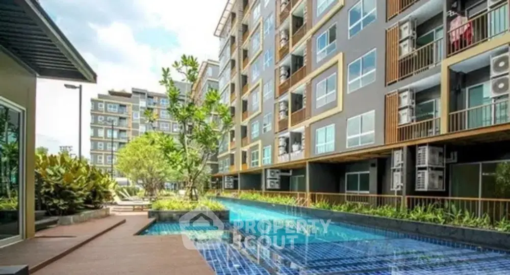 Modern condominium with pool and lush greenery, perfect for urban living.
