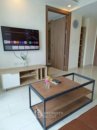 Modern living room with smart TV and stylish furniture in a contemporary apartment.