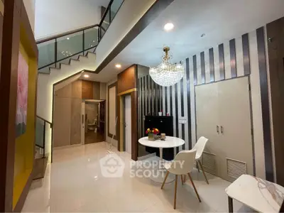 Elegant modern interior with chandelier and stylish decor in a spacious living area.