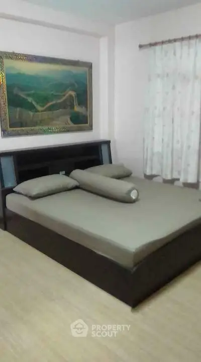 Cozy bedroom with elegant decor and large bed, perfect for relaxation.