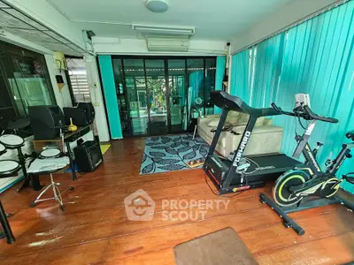 Spacious home gym with exercise equipment and natural light