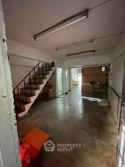 Spacious interior with staircase and open layout, ideal for creative renovation.