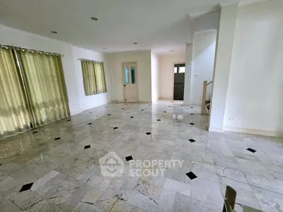 Spacious empty living room with marble flooring and natural light
