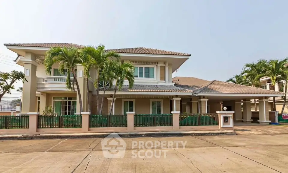 Elegant two-story house with palm trees and spacious driveway in suburban neighborhood.