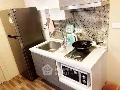 Modern compact kitchen with stainless steel fridge and mosaic backsplash