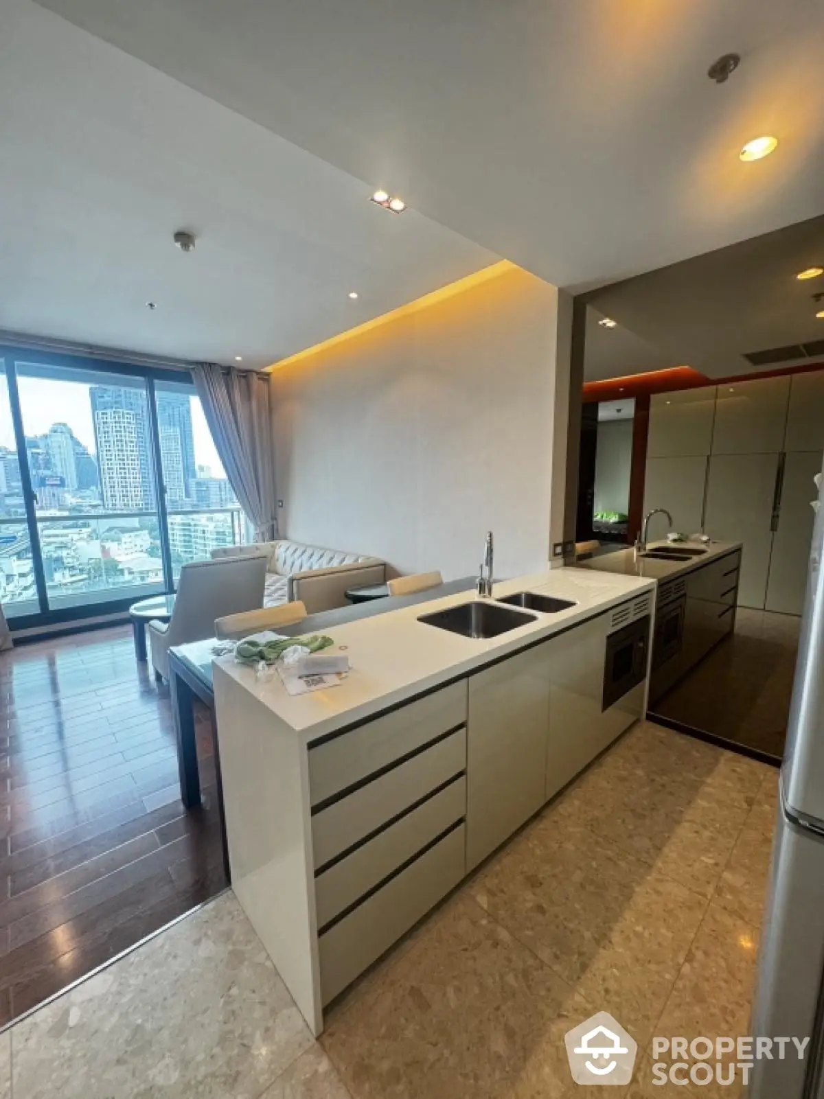 Modern open-layout kitchen with city view in luxury apartment