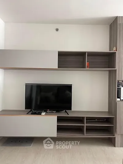 Modern living room with sleek TV unit and open shelving