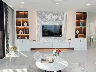 Luxurious modern living room with marble accent wall and built-in shelving