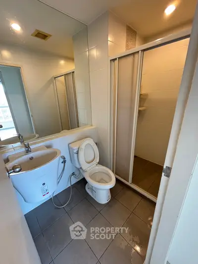 Modern bathroom with sleek fixtures and a spacious shower area.