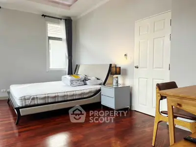 Spacious bedroom with modern furniture and natural light