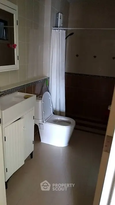 Cozy bathroom with modern fixtures and shower curtain in a stylish home.
