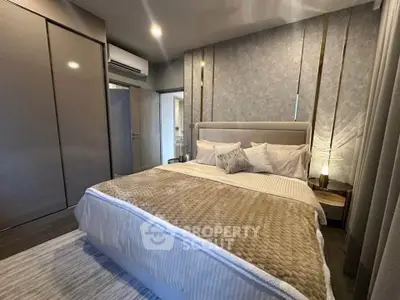 Luxurious modern bedroom with elegant decor and plush bedding in a stylish apartment.