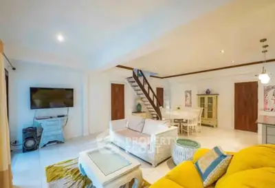 Spacious living room with modern decor and staircase in a stylish home