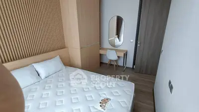 Modern bedroom with stylish wooden accents and a cozy bed, perfect for relaxation and comfort.