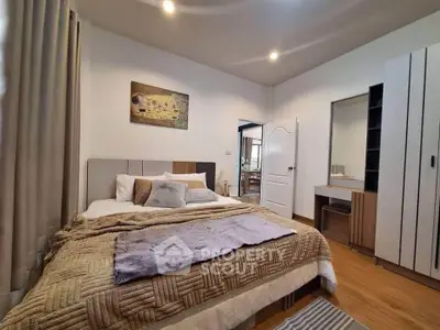Cozy bedroom with modern decor and ample natural light