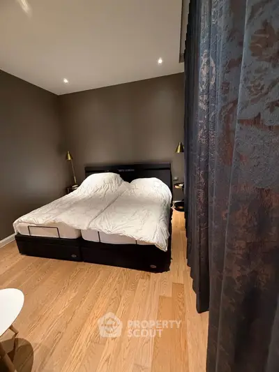 Spacious bedroom with twin beds and elegant decor, perfect for a cozy retreat.