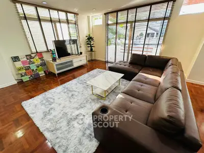 Spacious living room with modern decor and large windows for natural light.