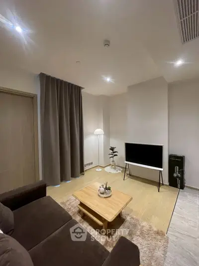 Modern living room with cozy sofa, stylish decor, and flat-screen TV