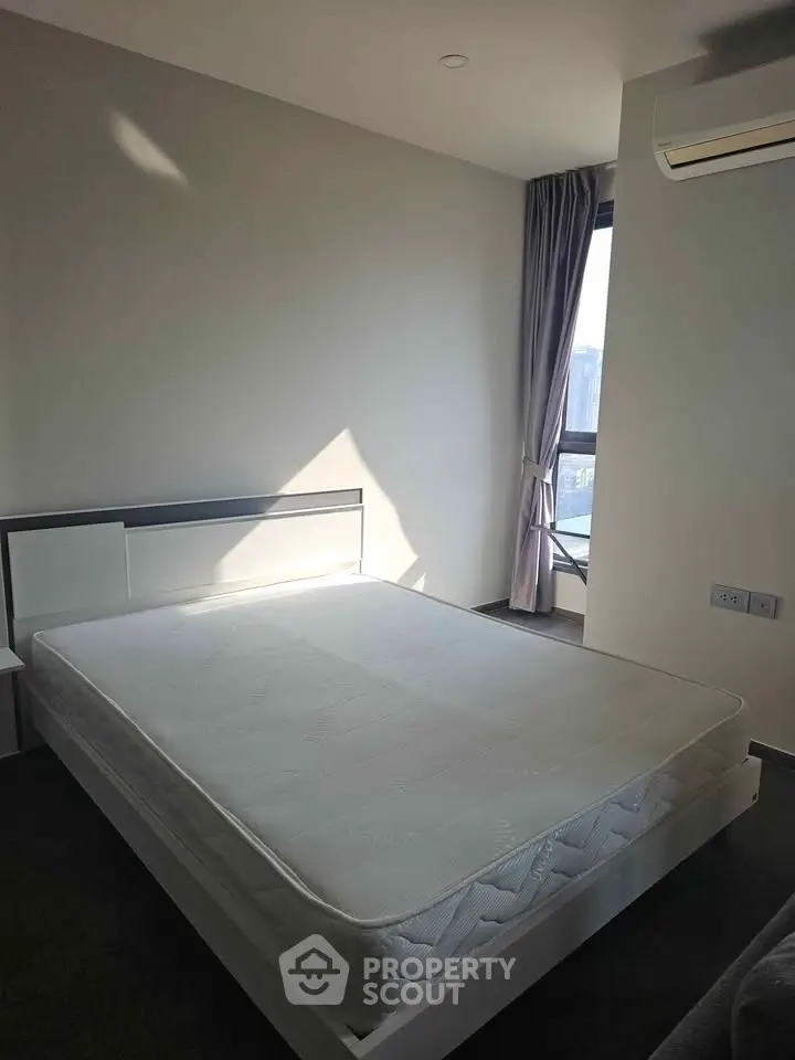 Modern bedroom with large window and air conditioning unit