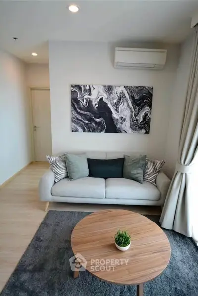 Modern living room with stylish decor and cozy seating area, perfect for relaxation.