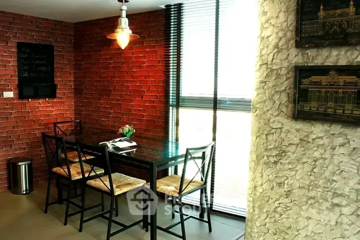 Chic dining area with exposed brick wall and modern lighting in stylish apartment