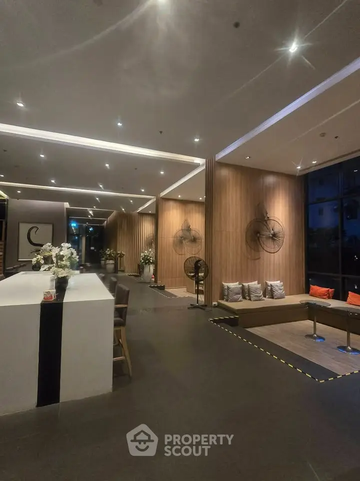 Luxurious modern lobby with elegant decor and ambient lighting in a high-end residential building.