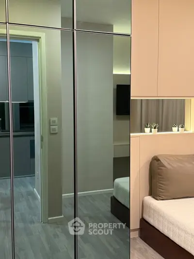 Modern bedroom with mirrored closet and sleek design