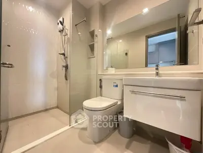 Modern bathroom with glass shower and sleek fixtures.