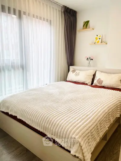 Cozy bedroom with large window and stylish decor in modern apartment