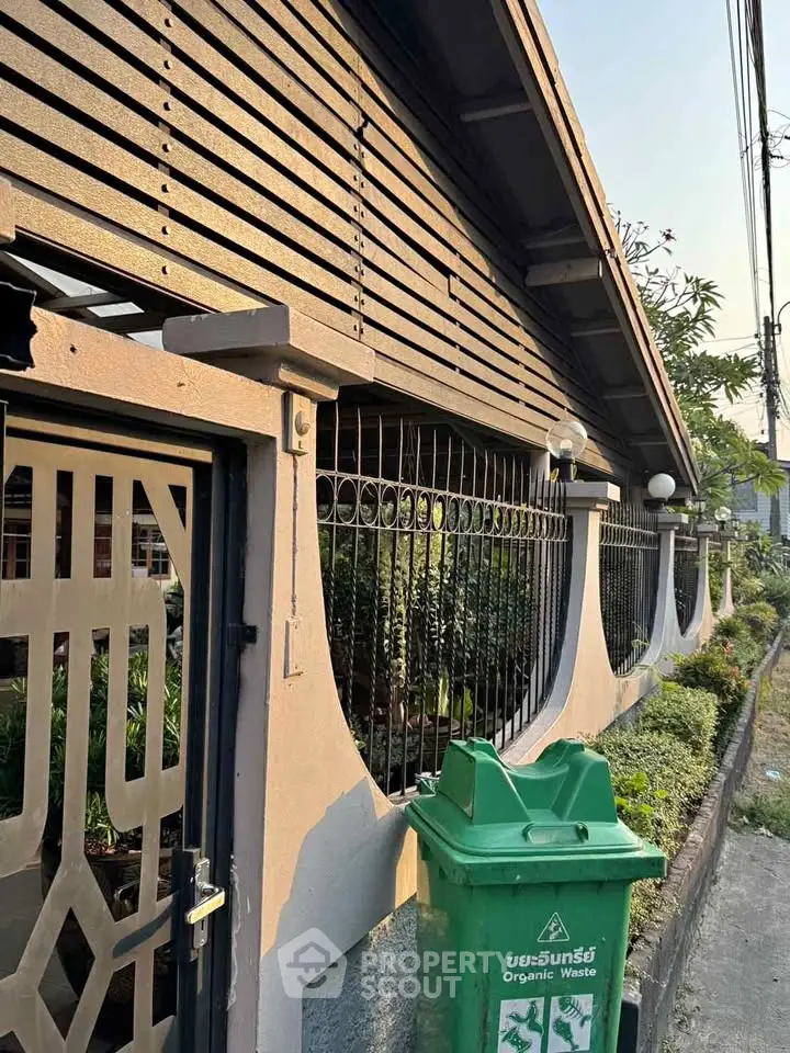 Charming residential exterior with unique architectural design and lush greenery, perfect for serene living.