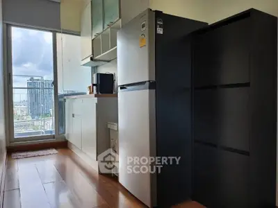Modern kitchen with sleek appliances and city view from balcony