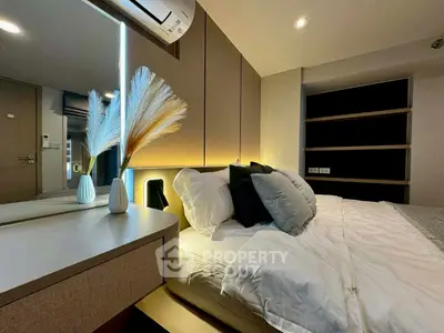 Modern bedroom with stylish decor and ambient lighting, featuring a cozy bed and elegant furnishings.