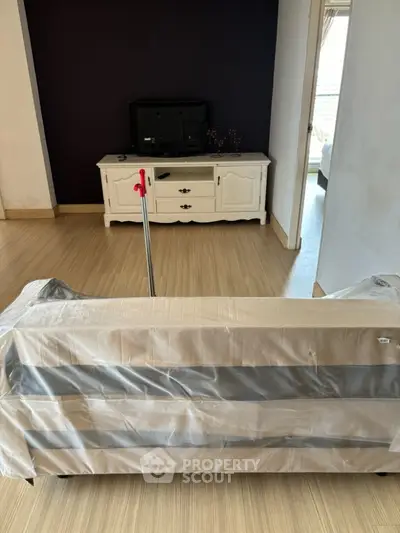 Spacious living room with wooden flooring and classic white furniture