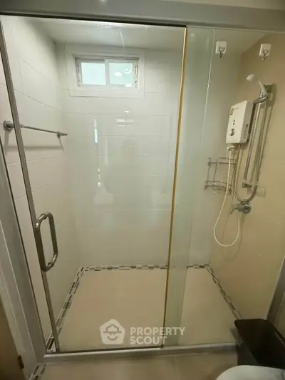 Modern bathroom with glass shower enclosure and water heater